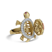 Tricolor gold turtle ring with hinged open shell revealing a miniature baby turtle inside.