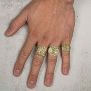 Small, medium, and large gold Centenario square coin rings modeled on a hand.