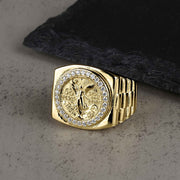 10k or 14k gold Centenario pesos CZ ring resting on a slate background.