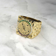 10k-14k gold square Centenario coin ring with colored stones on a marble surface.