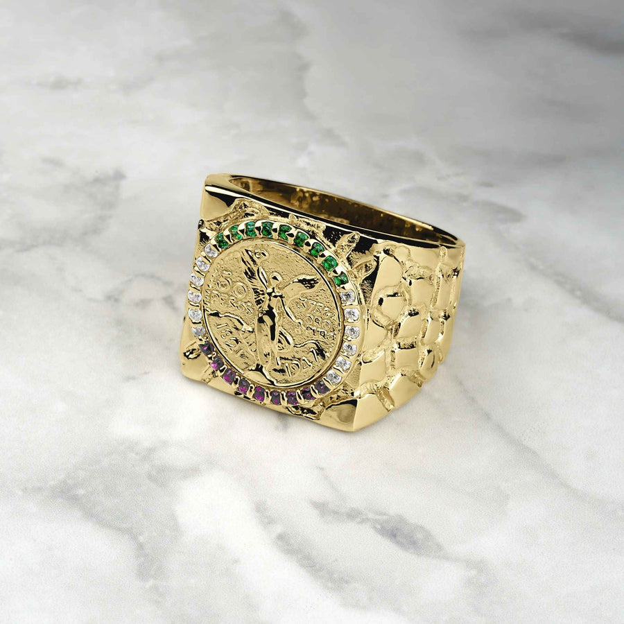 10k-14k gold square Centenario coin ring with colored stones on a marble surface.