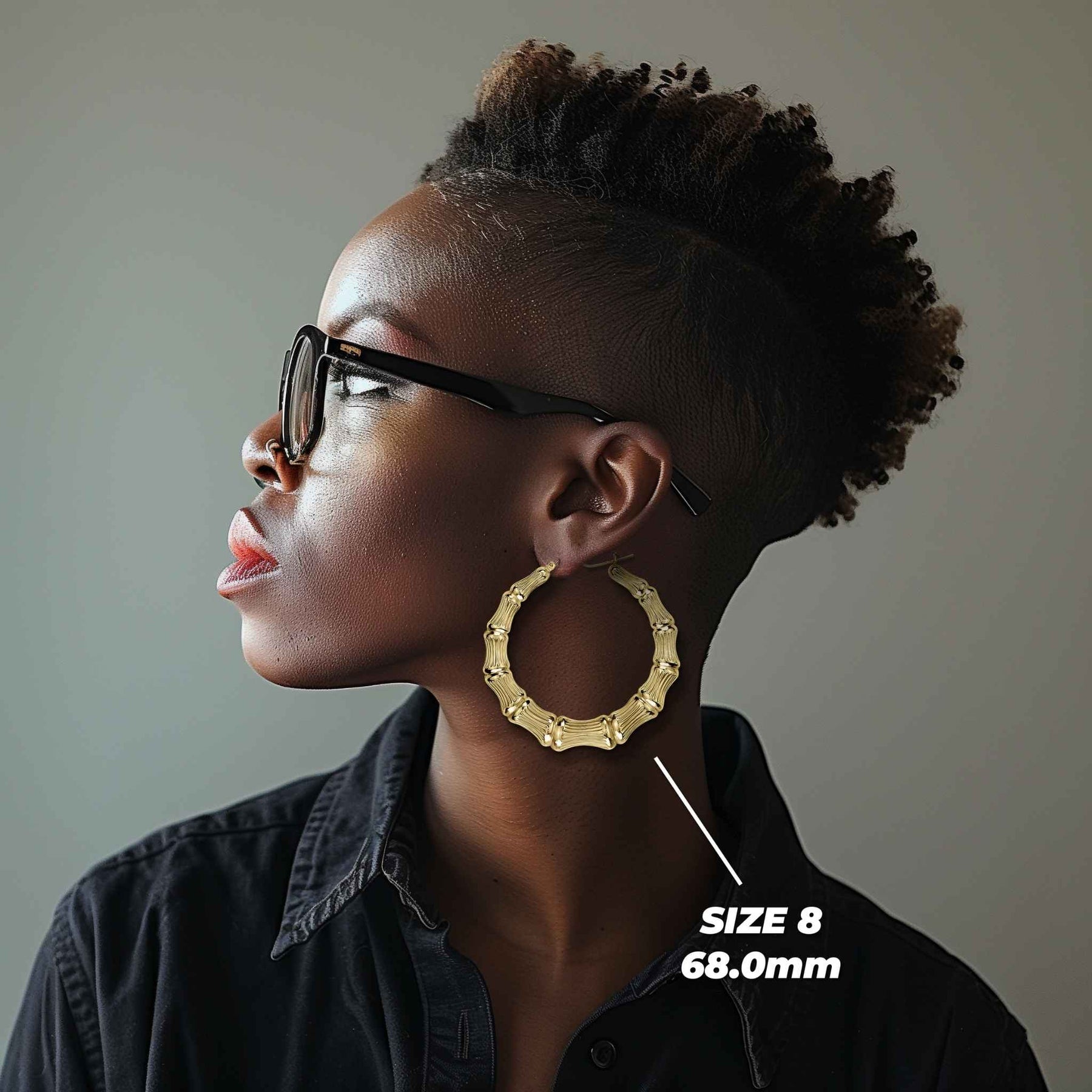 Side profile of a woman wearing 68mm 10k gold classic bamboo round hoop earrings.