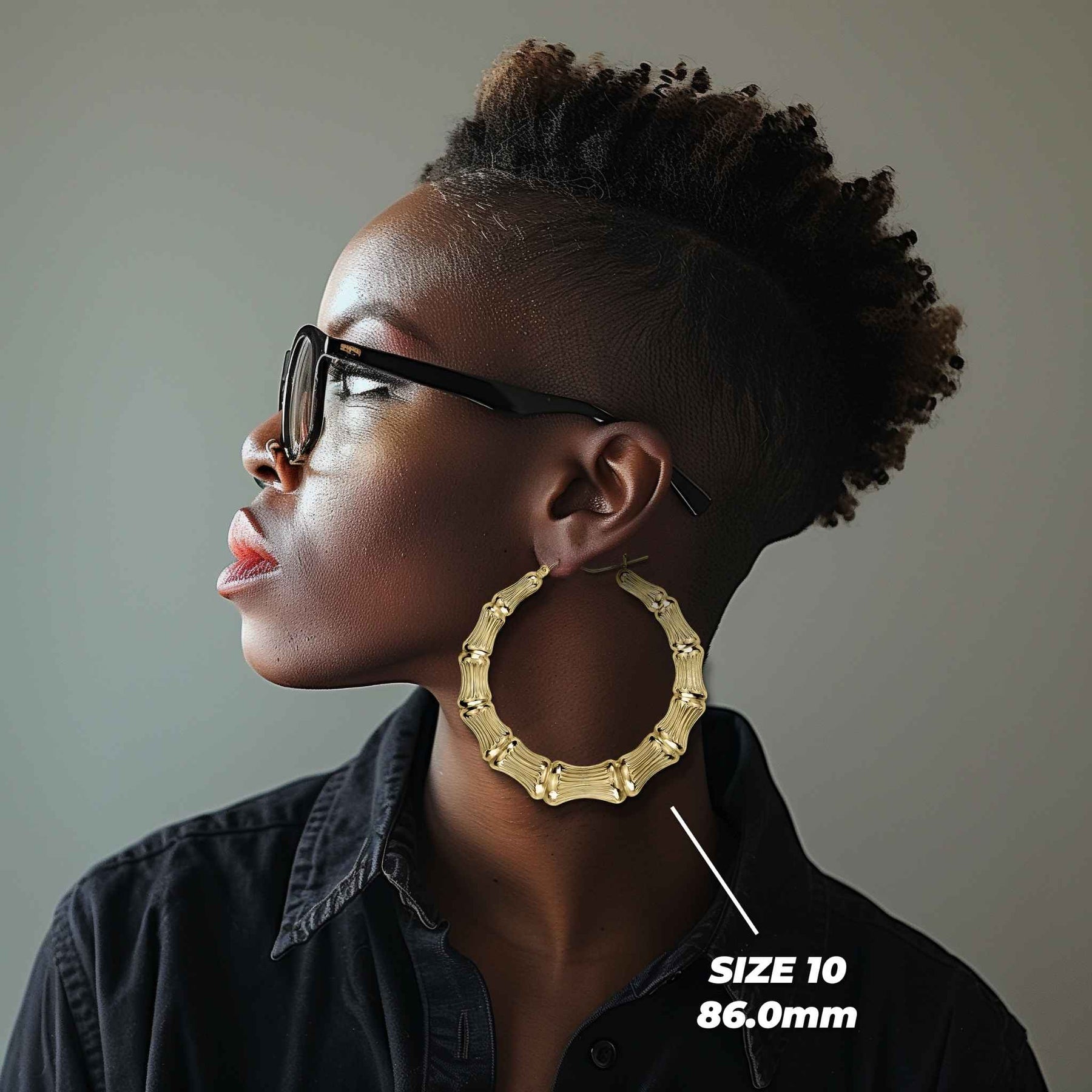 Side profile of a woman wearing 86mm 10k gold classic bamboo round hoop earrings.