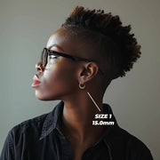 Side profile of a woman wearing 15mm 10k gold classic bamboo round hoop earrings.