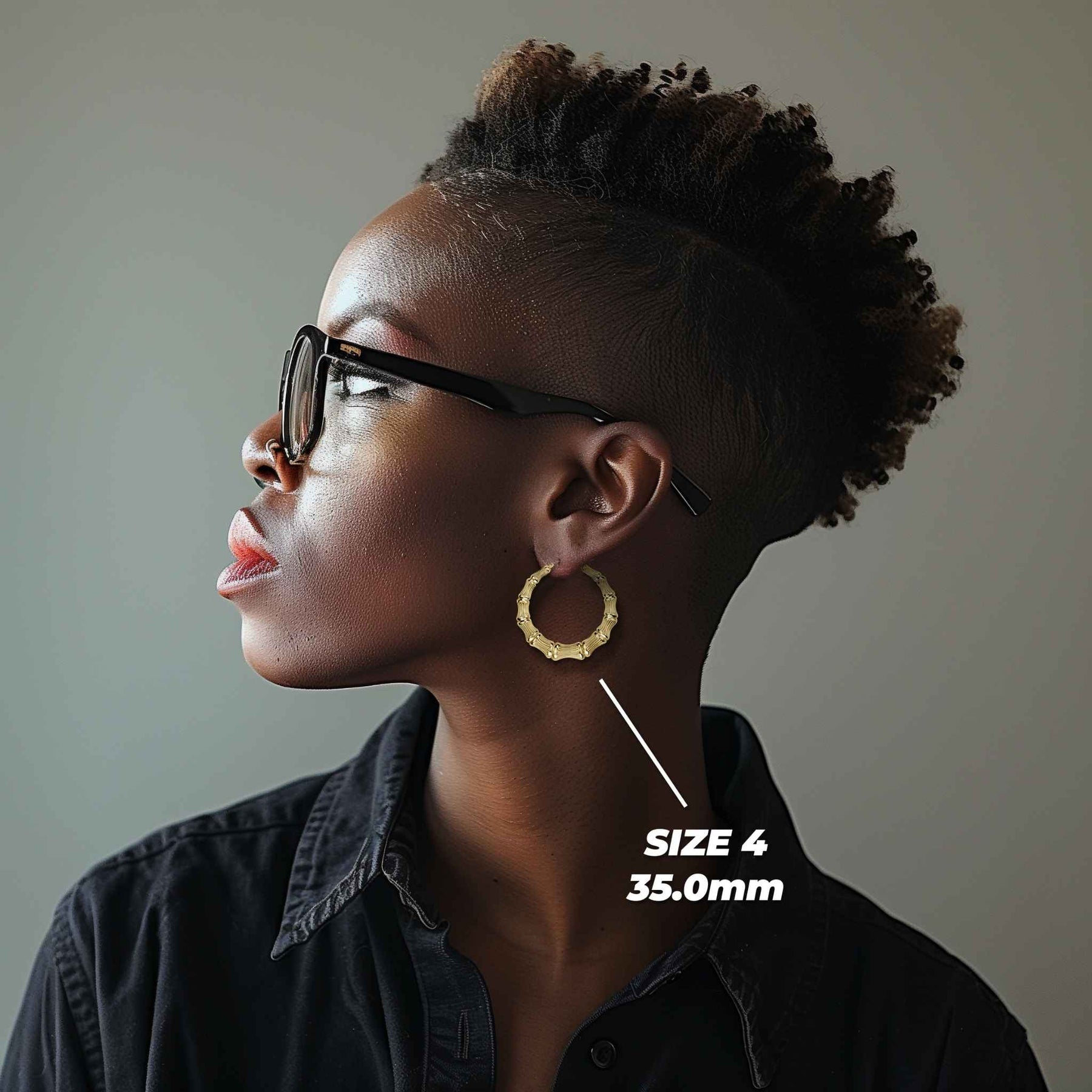 Side profile of a woman wearing 35mm 10k gold classic bamboo round hoop earrings.