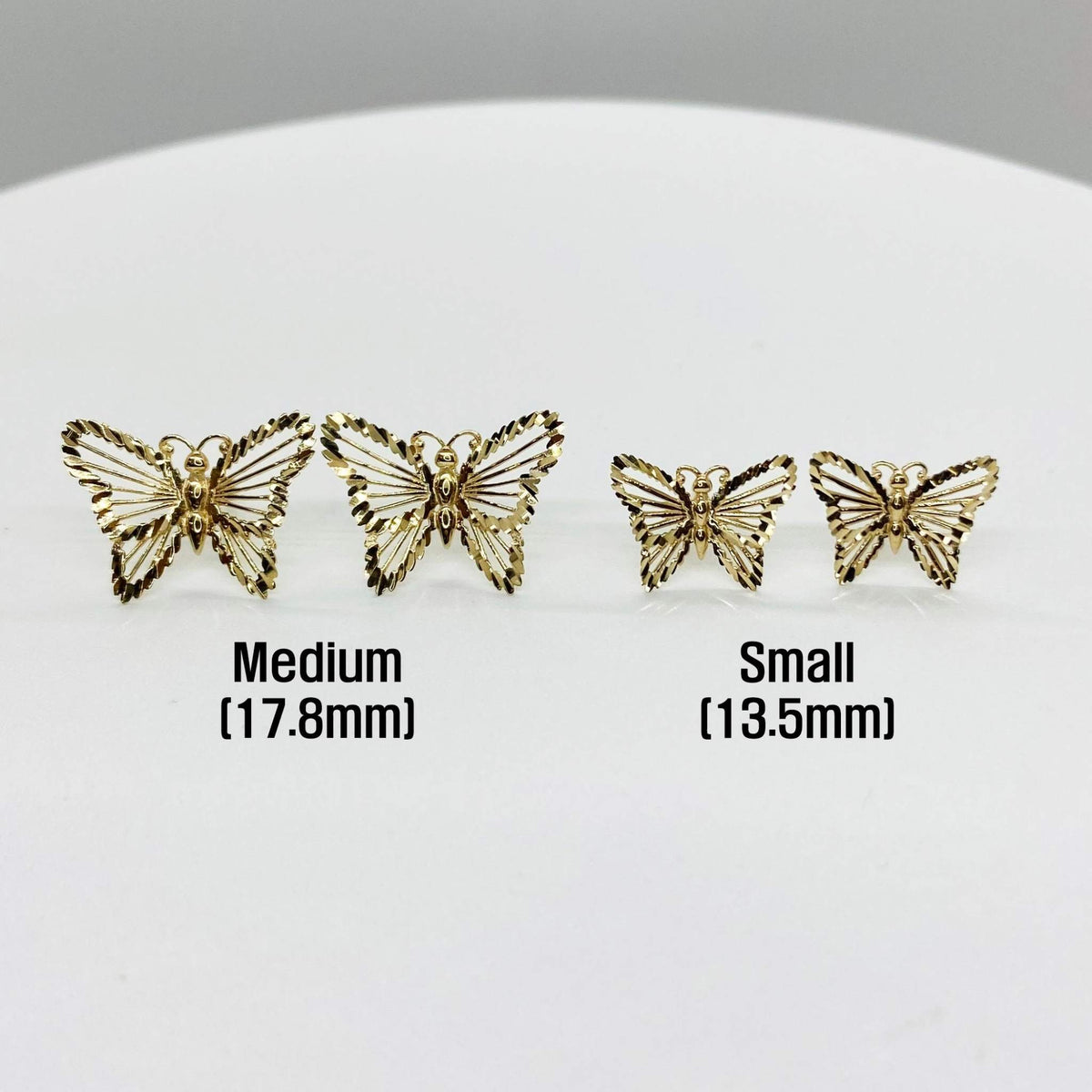 Two pairs of gold butterfly stud earrings shown in small and medium sizes with dimensions.
