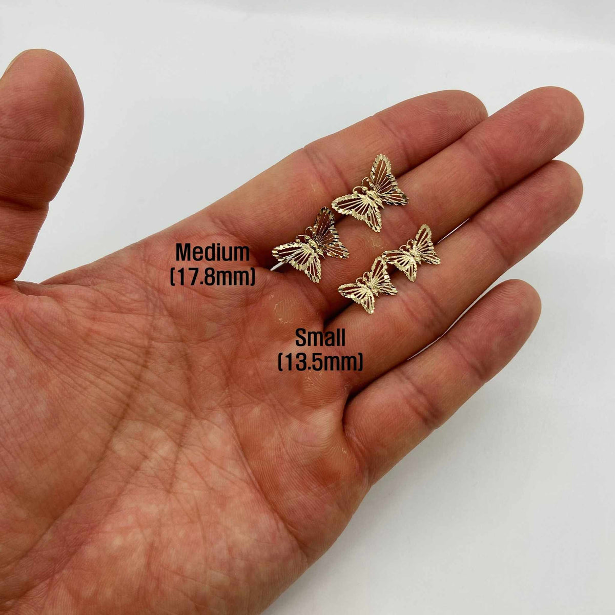 10k 14k gold classic butterfly stud earrings small and medium hand size comparison.