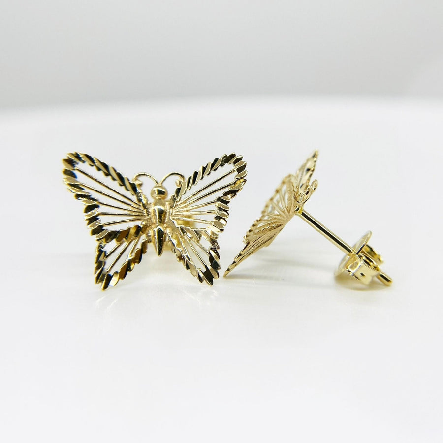 Front and side view of gold classic textured butterfly stud earrings on white background.