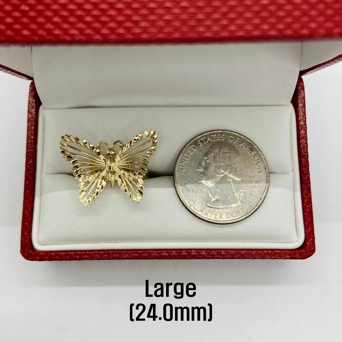 10k - 14k Gold butterfly ring next to a quarter in a red box