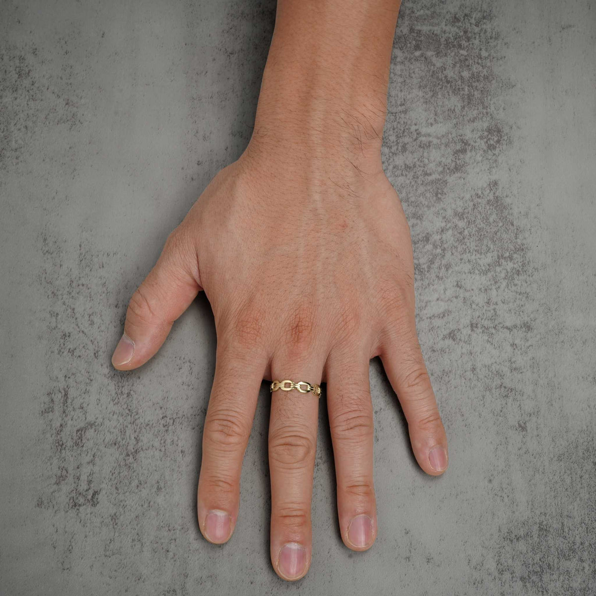 Hand wearing a solid 10k or 14k gold classic Rolo chain link ring.
