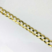 Detailed close-up view showing the flat, interlocking links of a solid gold Cuban curb chain.