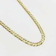 Polished yellow gold classic Cuban curb chain necklace on white background.