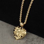 Textured 10k or 14k gold heart-shaped nugget pendant hanging from a classic rope chain.