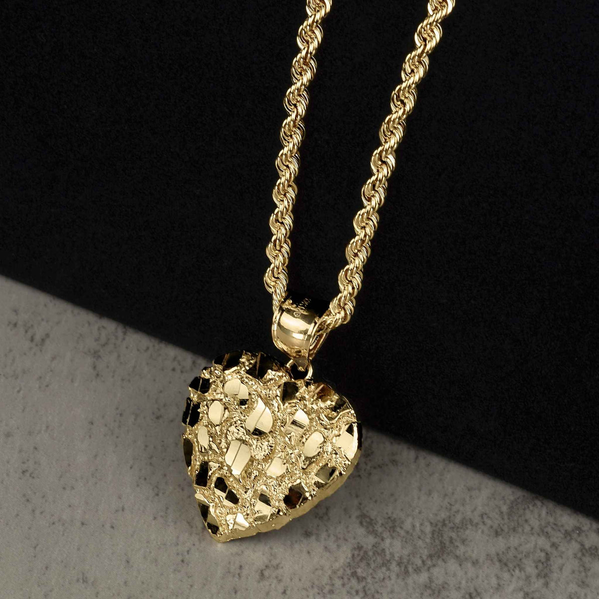 Textured 10k or 14k gold heart-shaped nugget pendant hanging from a classic rope chain.