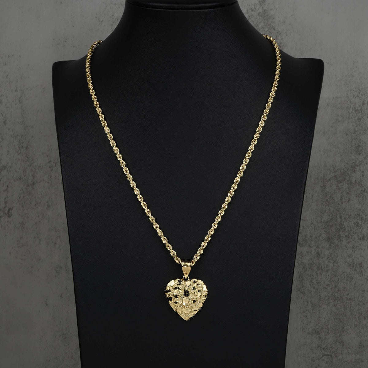 Textured 10k or 14k gold heart-shaped nugget pendant hanging from a classic rope chain.