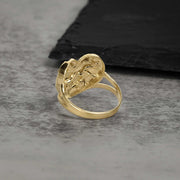 Back view of a yellow gold heart nugget ring showing the smooth split-shank band.