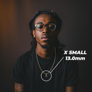 Model wearing an extra-small 13mm gold initial 'A' pendant labeled X SMALL 13.0mm.