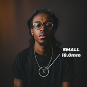 Model wearing a small 18mm gold initial 'A' pendant labeled SMALL 18.0mm on a black shirt.