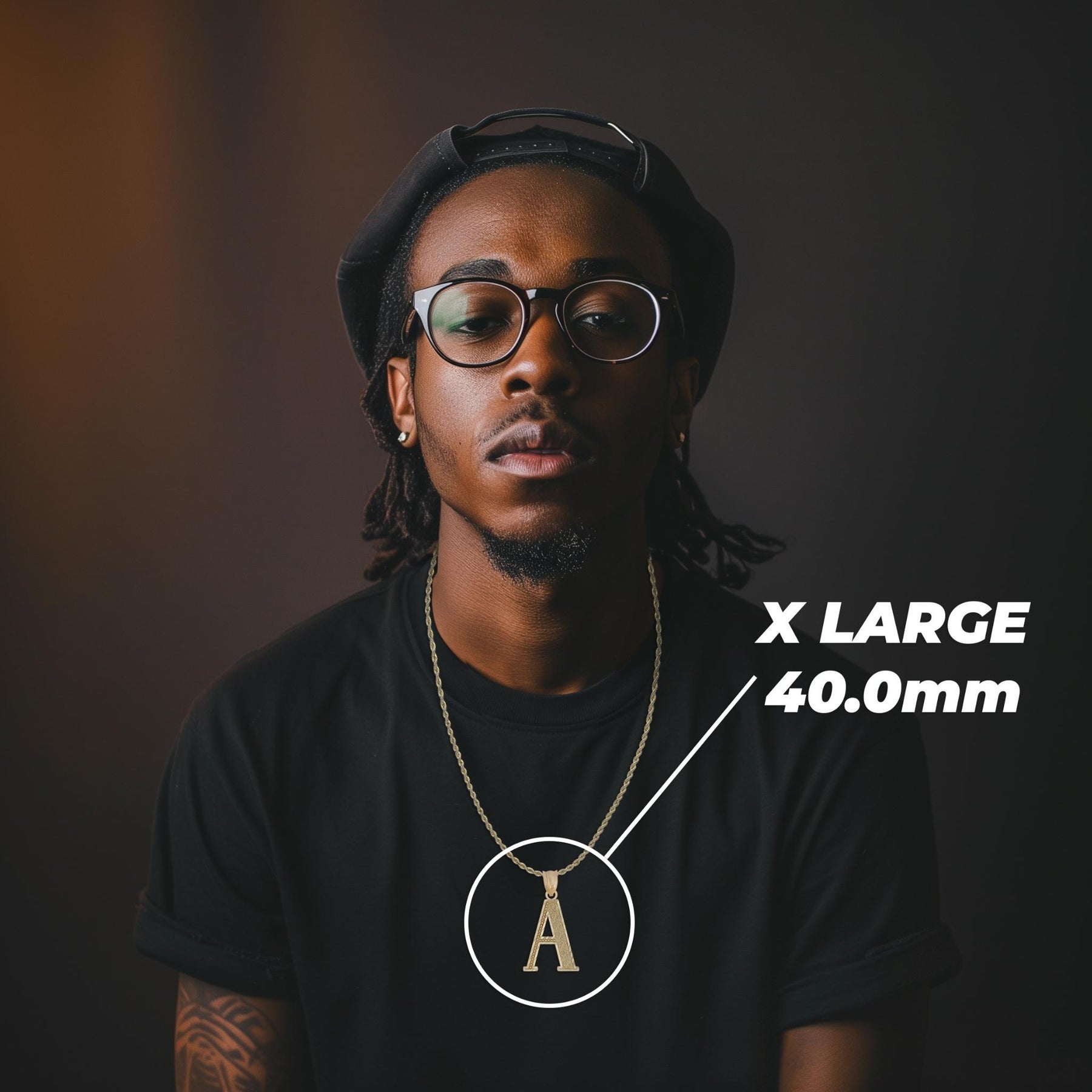 Model wearing an extra-large 40mm gold initial 'A' pendant labeled X LARGE 40.0mm.