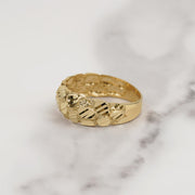 Textured 10k or 14k gold classic nugget band ring displayed on marble.