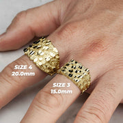 Two bold, textured yellow gold square nugget rings displayed on a hand for scale.