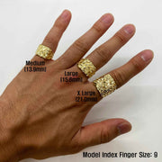 Hand wearing three 10k - 14k gold rings of different sizes on a white background