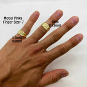 two 10k - 14k gold ring on a hand with size labels for different finger sizes.