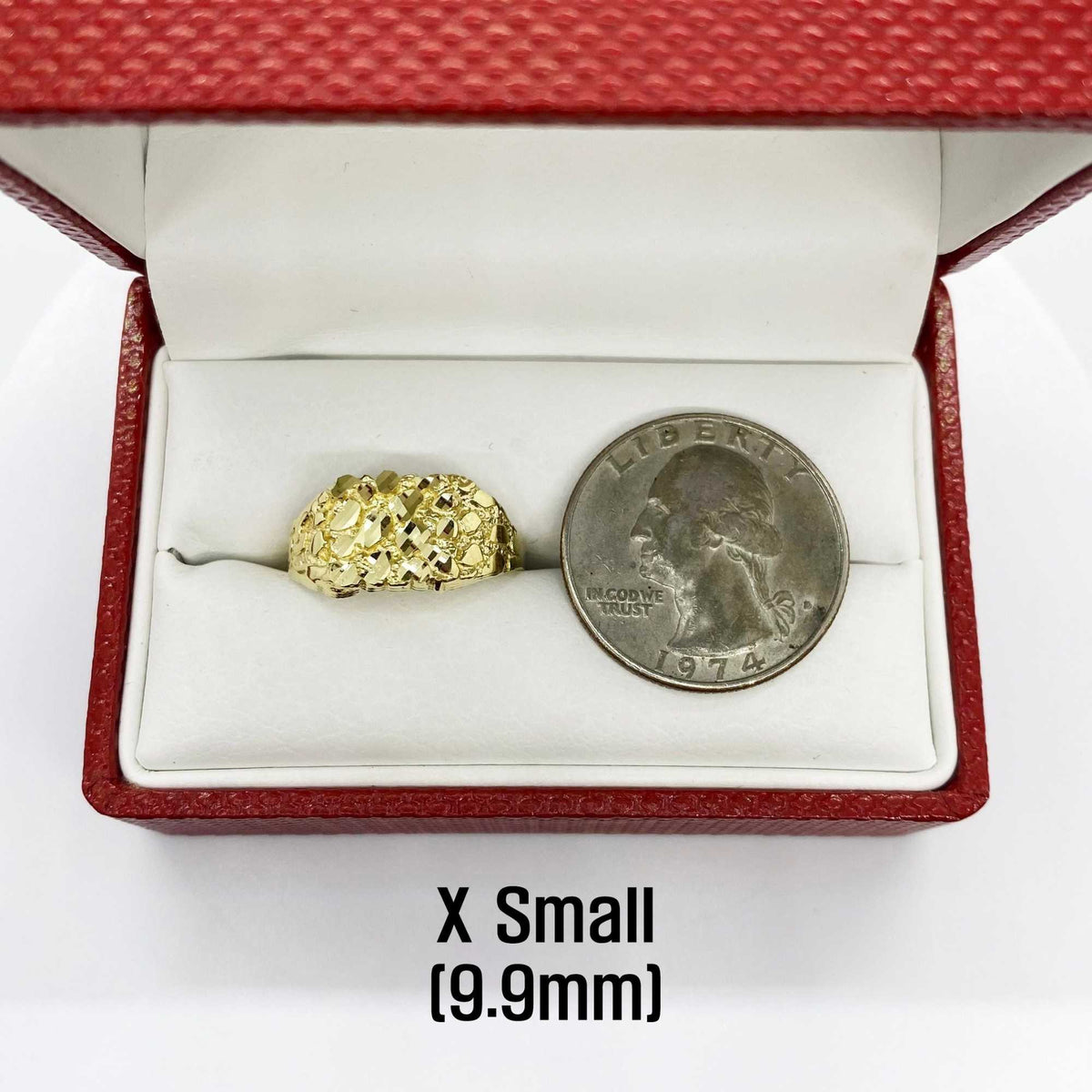 10k - 14k Gold ring in a red box with a coin for size reference on a white background