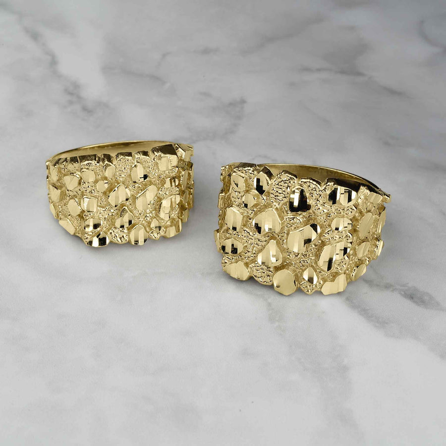 Two yellow gold classic nugget square rings side-by-side on a white marble background.