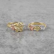 Two 10k- 14k floral patterned gold with white gold and rose gold on a gray surface.