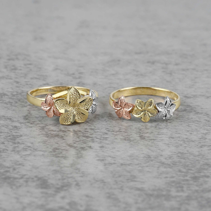 Two 10k- 14k floral patterned gold with white gold and rose gold on a gray surface.