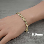 Person wearing an 8.0mm gold concave nugget heart link bracelet on their wrist.