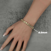 Person wearing an 8.0mm gold concave nugget heart link bracelet on their hand.