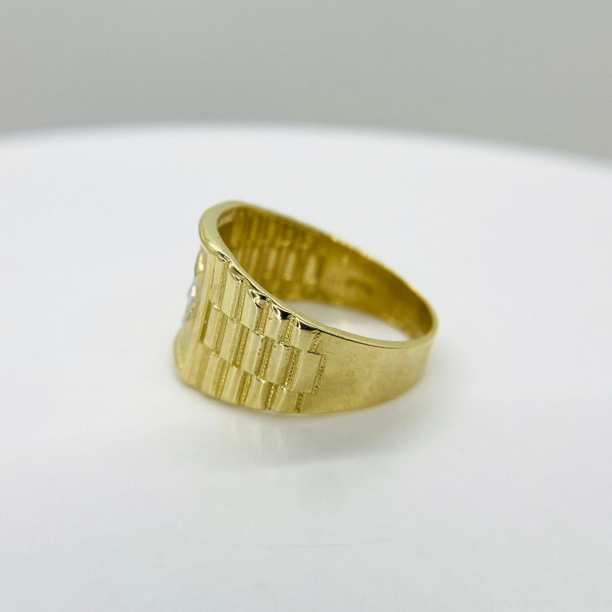 10k - 14k Gold Rollie Band ring with a dollar sign and textured band side view 