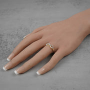 On-model view of the 10k or 14k gold Elio infinity ring on a finger.