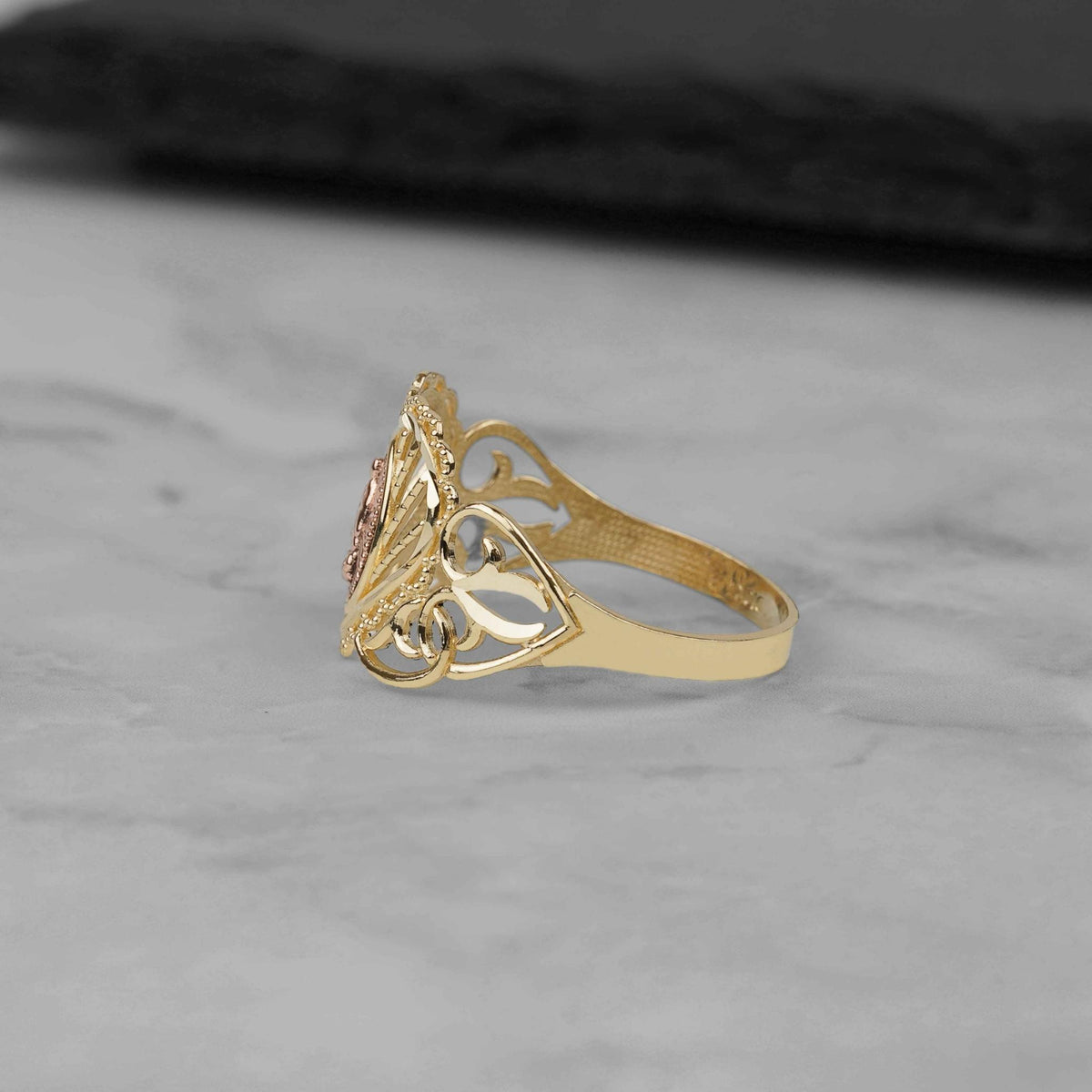 Side profile of the 10k and 14k gold Elyra heart Virgin Mary ring.