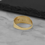 Underside view of the tricolor gold Evora lucky elephant ring showing its interior structure.