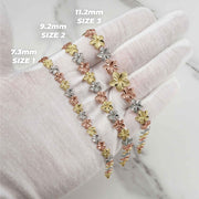 Gloved hand displaying three gold hibiscus flower bracelets with width and size labels.