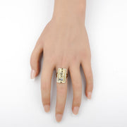 Two-tone gold Good Shepherd Jesus rectangle ring worn on a middle finger.
