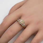Close-up of a model's hand wearing a two-tone gold Virgin Mary ring with CZ accents.