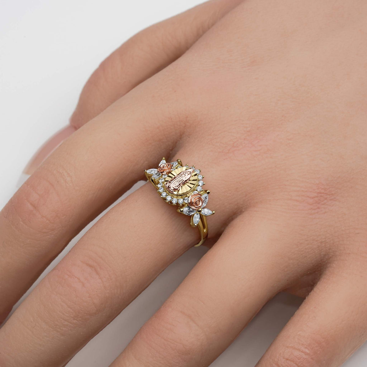 Close-up of a model's hand wearing a two-tone gold Virgin Mary ring with CZ accents.