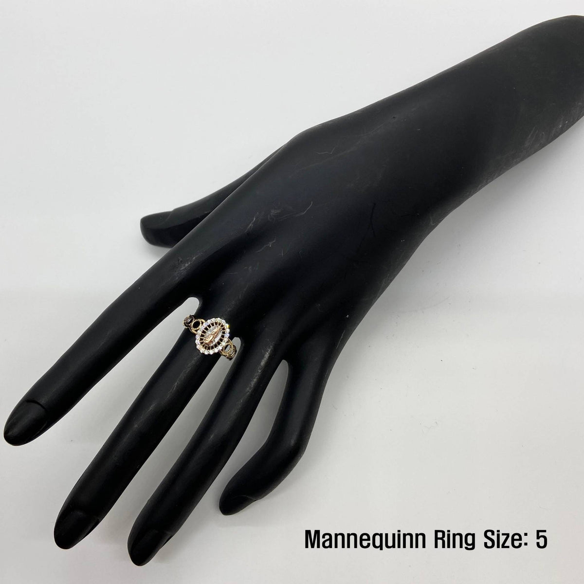 Black mannequin hand wearing a 10k - 14k gold oval ring with Size 5 text.
