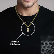 A man wearing a medium gold Hamsa hand pendant on a black shirt.