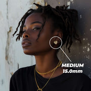 Female model wearing a medium 15.0mm gold heart nugget stud earring.