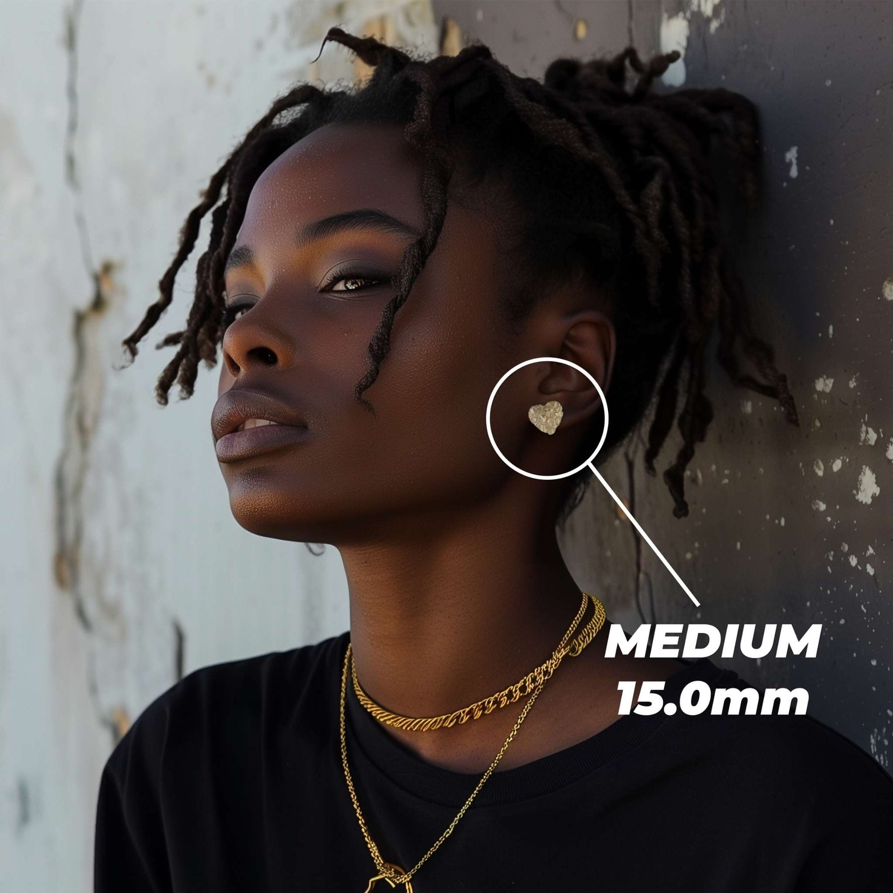 Female model wearing a medium 15.0mm gold heart nugget stud earring.