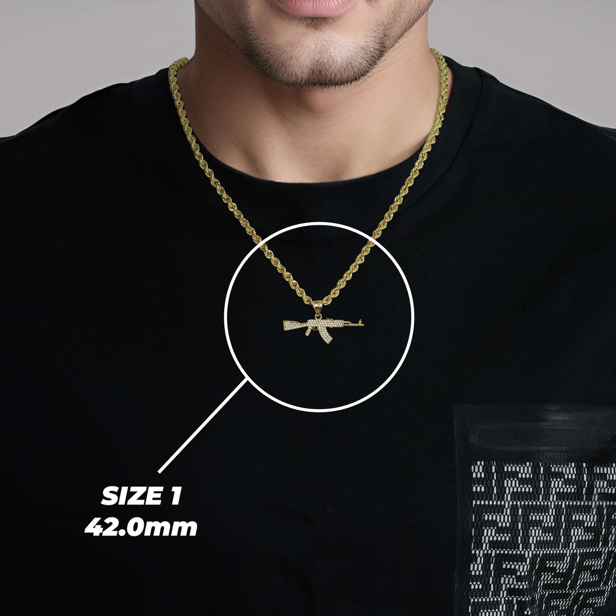 A man wearing a black shirt and gold chain displaying Size 1 (42.0mm) AK-47 pendant.