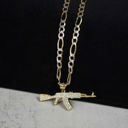 A gold chain necklace featuring an iced AK-47 pendant against a split background.