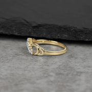 Side view of a gold infinity ring showcasing curved cubic zirconia stone settings