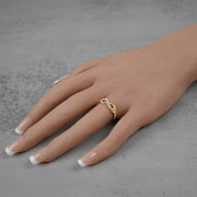 10k or 14k gold infinity symbol ring with cubic zirconia styled on a hand