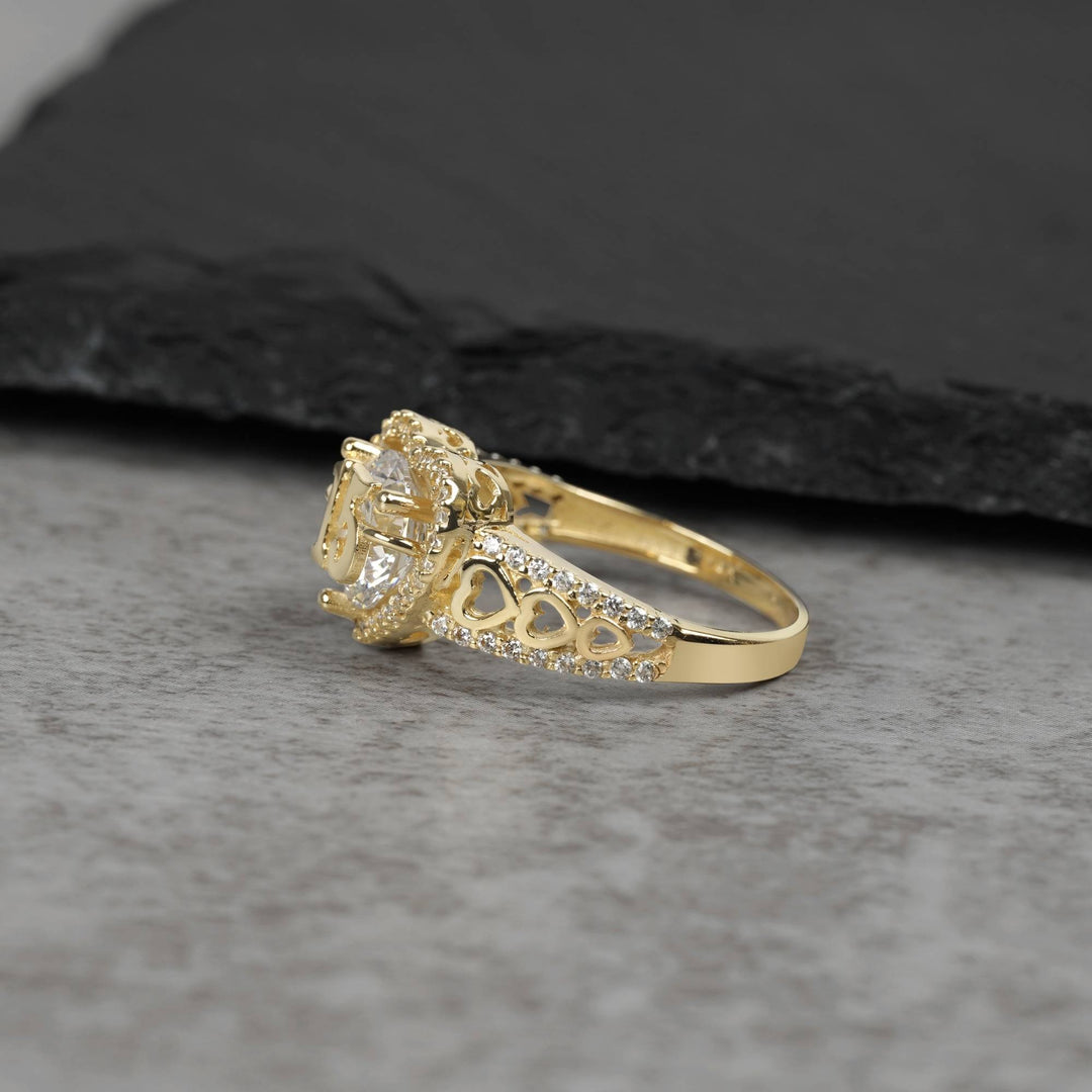 10k - 14k Gold ring with Cubic Zirconia accents on a gray surface sideview